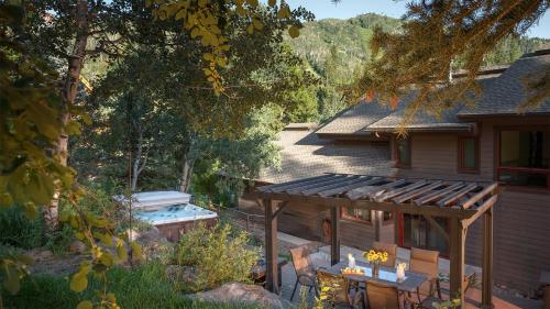 a house with a deck and a swimming pool at Orion Lodge in Steamboat Springs