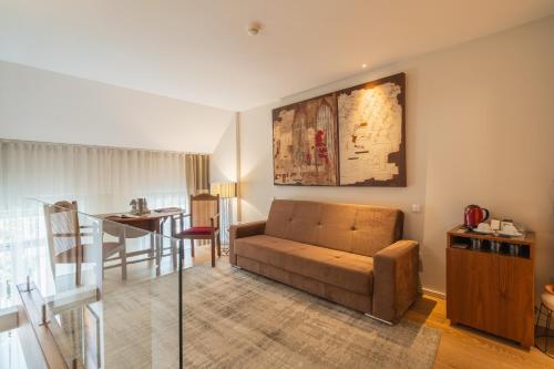 a living room with a couch and a table at Burgus Tribute & Design Hotel in Braga