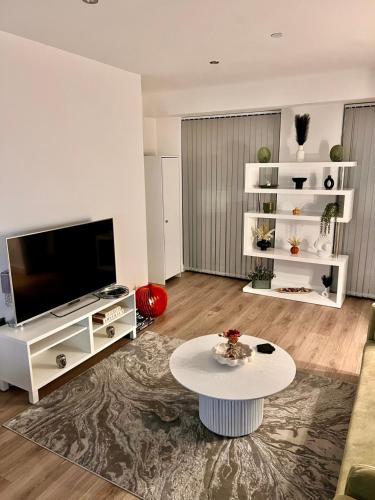 a living room with a tv and a table at Beautiful, home from home, one bed stay in Olton