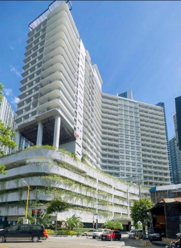 a large white building with cars parked in front of it at New 1BR Haven Suite Lush Residences Smart TV Netflix Hi speed internet in Manila