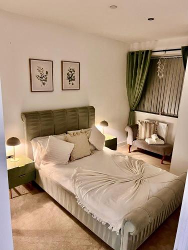 a bedroom with a large bed and a couch at Beautiful, home from home, one bed stay in Olton