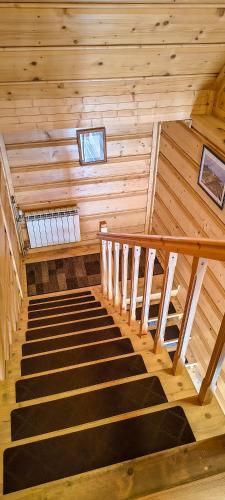 a staircase in a wooden cabin with a window at Pokoje Pod Cyrlicą u Józi in Chochołów