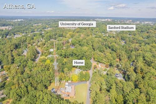 an aerial view of a forest of trees with houses at Classic City Apartment w Firepit in Athens