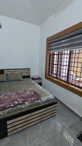 a bedroom with two beds and a window at The Soul 1 Service Villa in Mananthavady