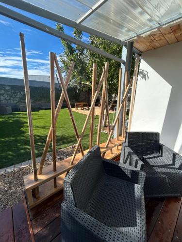 a screened in porch with two chairs on a deck at La Calypso maison atypique in Sète