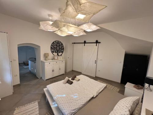 a living room with a bed and a chandelier at City Center Deluxe in Kranj