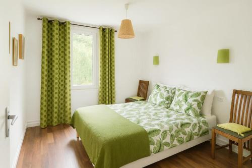 a bedroom with a bed and a window at La maison de LOUELYNE 