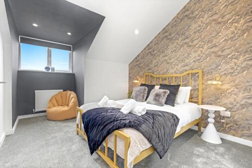 a bedroom with a bed and a stone wall at Mystic Heights- Wyndale Signature Stays in Worcester