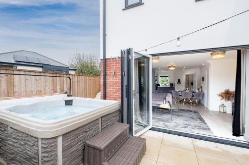 a hot tub in a backyard with a patio at Mystic Heights- Wyndale Signature Stays in Worcester