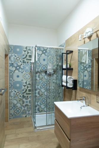 a bathroom with a shower and a sink at Lætitia Cottage Apartment in Aversa