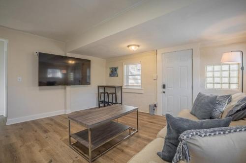 a living room with a couch and a table at Caras Cottage - 2 miles from Sanford Stadium in Athens