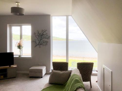 a living room with a view of the ocean at Gleaner Lea Apartment in Campbeltown