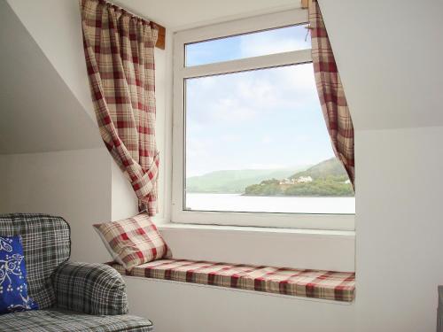 a window seat with a view of the ocean at Fleet Cottage in Portree