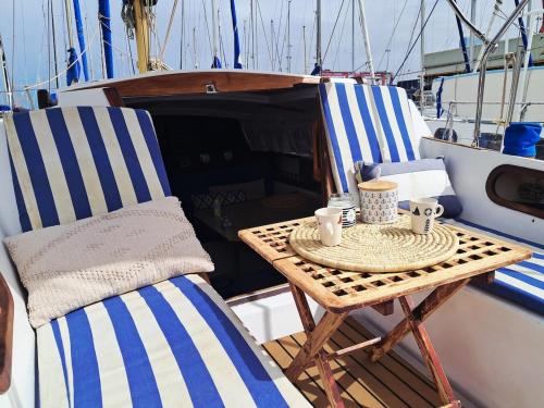 a table and chairs sitting on a boat at Romantic getaway on a sailboat in the Tagus in Lisbon
