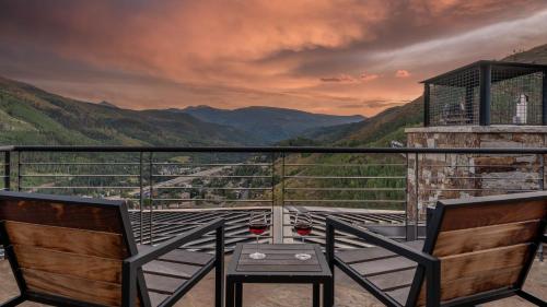 a balcony with two chairs and a view of the mountains at Radiance Retreat in Vail