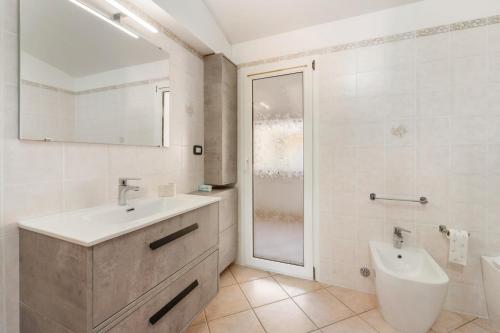 a bathroom with a sink and a toilet and a shower at Mayor's House in Iglesias