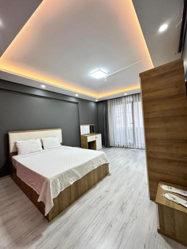 a bedroom with a large bed in a room at Renaissance Apart Hotel in Trabzon