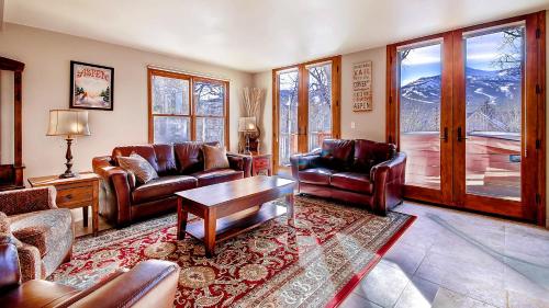 a living room with couches and a table at Ravens Bungalow in Breckenridge