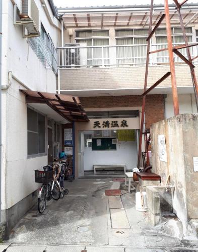 an outside view of a building with a garage at Close to Beppu station and cheap! Free parking! Fully renovated in Beppu