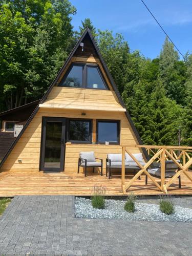 a tiny house with a pitched roof at Brda 5 osobowa z jacuzzi in Zawoja