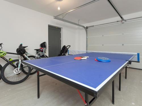 a ping pong table in a room with bikes at Strathspey Lodge in Duthil