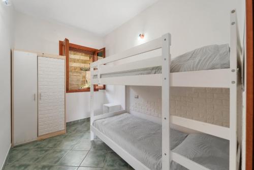 a bedroom with two bunk beds in a room at Buggerru Hugo House in Buggerru