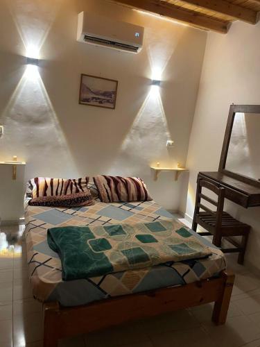 a bedroom with a bed and a table and lights at Mountain view House in Dahab