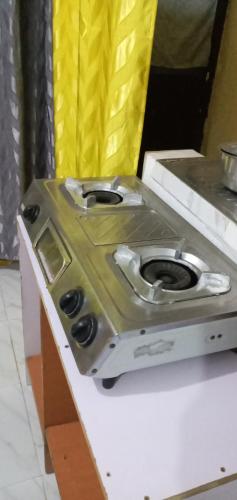 a stove sitting on top of a counter at Royalcarevillas in Thika