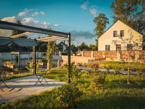 a garden with a white house in the background at Holiday Home Ayurvedic Palace by Interhome 