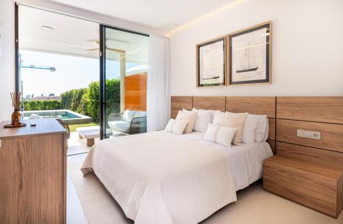 a bedroom with a large bed and a balcony at Eden Retreat Luxury 2BR with Private Pool in Fuengirola