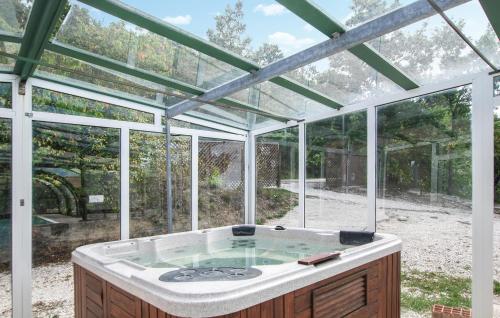 a hot tub inside of a glass house at Country House Chiciabocca in Apecchio
