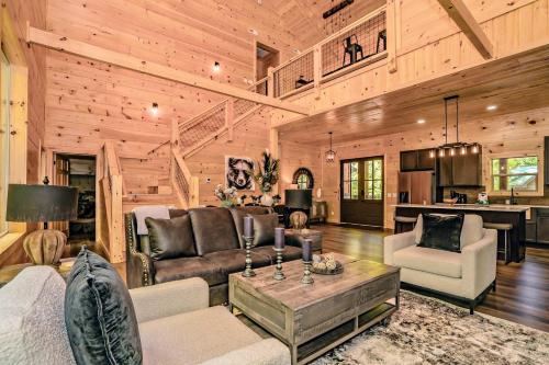 a living room with a couch and a table at Luxury Cabin with Hot Tub, Game Room and Movie Theater in Sevierville