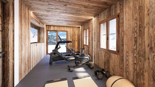 a gym in a wooden cabin with a chair in it at Chalet unique haut de gamme au centre de La Clusaz in La Clusaz
