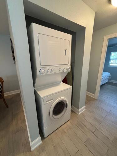 a white washer and dryer in a room at Gecko - LRG Deck River Kayak Launch Updated 1.3M To Beach in Bonita Springs