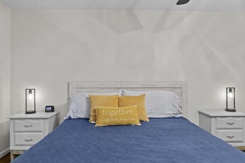 a bed with a blue comforter and two night stands at P Js Inlet - Pet Friendly Oasis in Lavonia