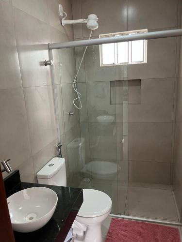 a bathroom with a shower and a toilet and a sink at CF Flat 03 in Petrolina
