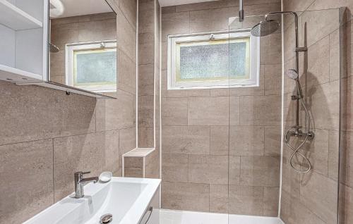 a bathroom with a shower and a sink and a tub at Lovely Home In Nanteuil-En-Vallée With Wifi in Nanteuil-en-Vallée