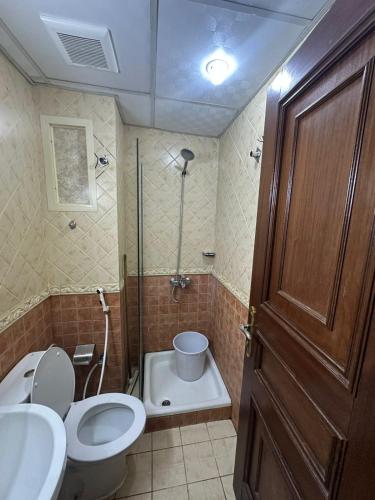 a bathroom with a toilet and a sink and a shower at قاصد الخير in Ajyad