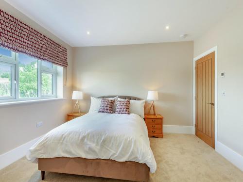 a bedroom with a bed and a window at The Cartlodge - Uk48579 in Rochford