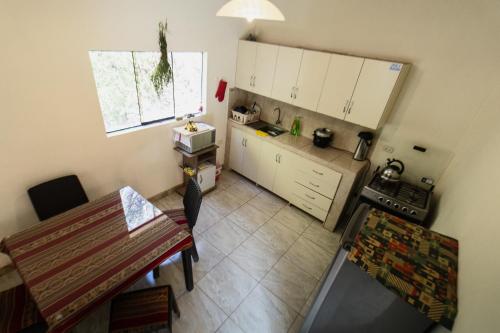 an overhead view of a kitchen with a table at Pinkuylluna Lodge in Ollantaytambo