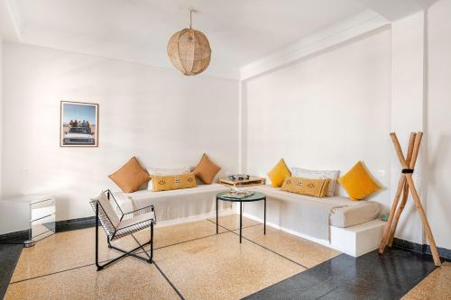 a living room with a white couch and a table at Maison Alcazar in Tangier