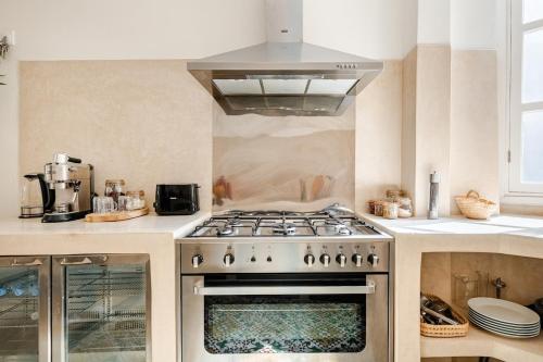 a kitchen with a stove top oven in a kitchen at Maison Alcazar in Tangier
