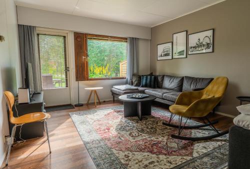 a living room with a couch and a table at Cozy Ranua Koivutie townhouse with sauna & terrace in Ranua