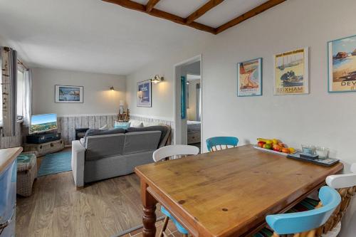 a living room with a table and a couch at No 1 Cottage in Brixham