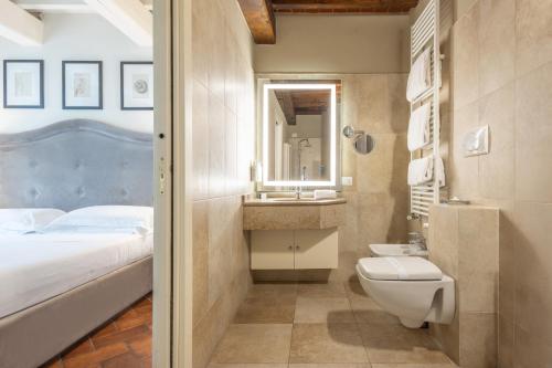 a bathroom with a bed and a sink and a toilet at Hotel Embassy in Florence