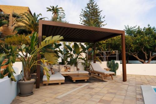 a gazebo with chairs and tables on a patio at Emesh Boutique Suite in Agrigento