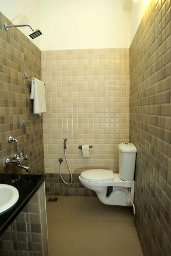 a bathroom with a toilet and a sink at Dr Nisha's Vedic Remedies in Trivandrum