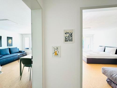 a bedroom with a bed and a living room at JJ Living - Bergzeit 160 in Scheidegg