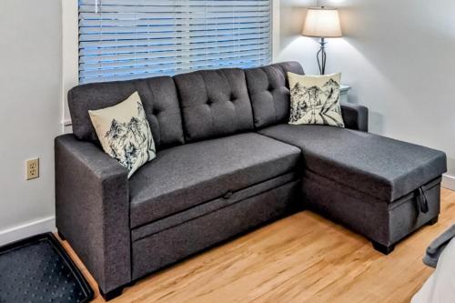 a grey couch in a living room with a lamp at Ludlow A Go Go in Ludlow