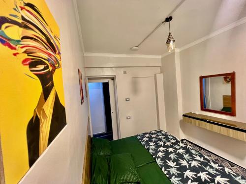 a room with a bed and a painting on the wall at Super Elite apartment - Aswan city center apartments in Aswan